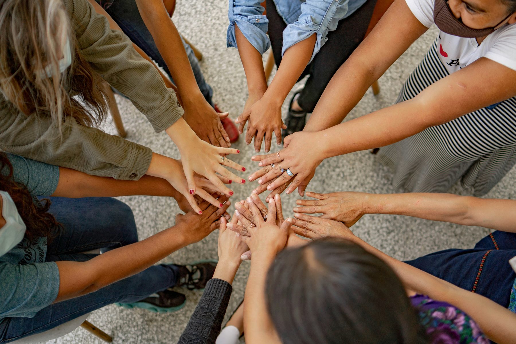Hands joined together in a team huddle